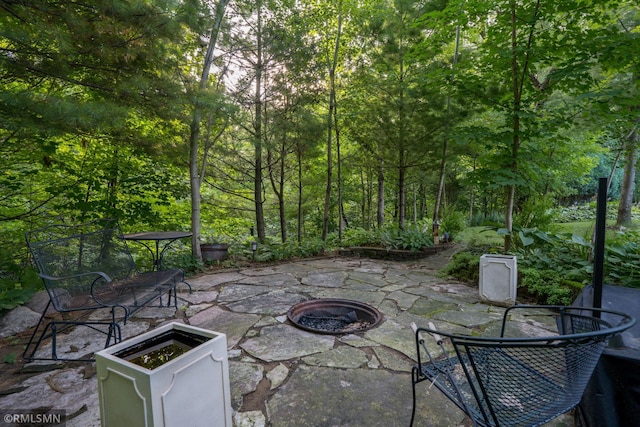 view of patio / terrace featuring an outdoor fire pit