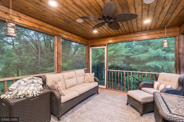 sunroom featuring ceiling fan and wood ceiling