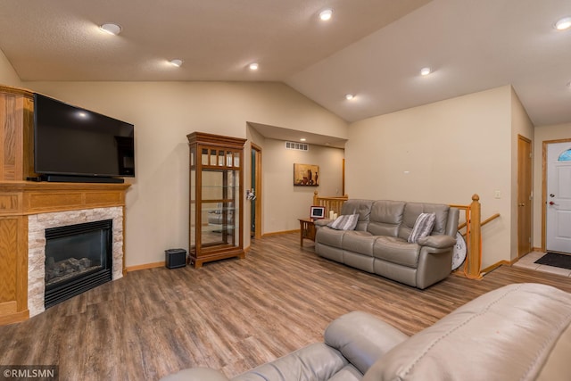 living room with light hardwood / wood-style floors and vaulted ceiling