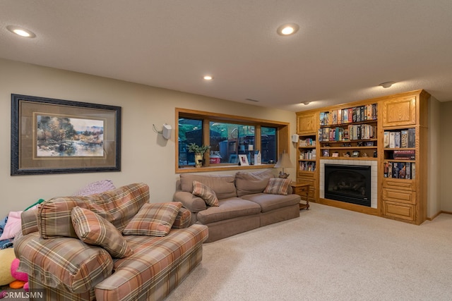 living room with light carpet and a tiled fireplace