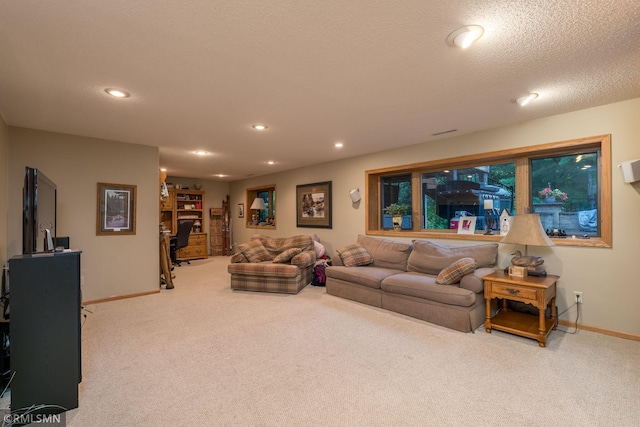 living room with carpet floors and a textured ceiling