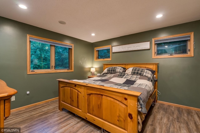 bedroom with hardwood / wood-style flooring