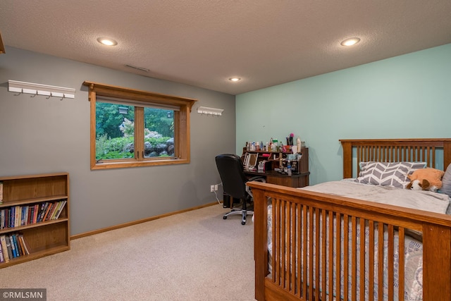 carpeted bedroom with a textured ceiling