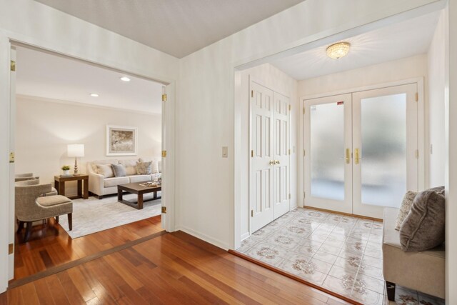 foyer entrance featuring french doors and light wood-type flooring