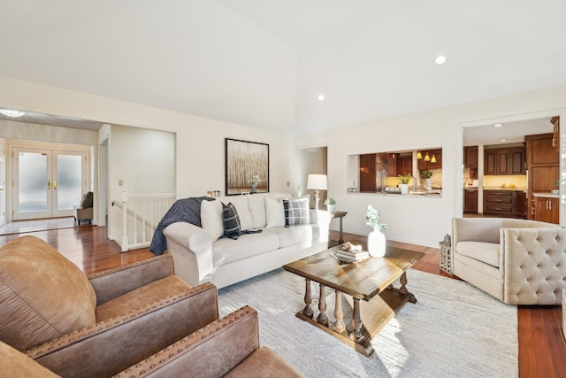 living room featuring french doors, high vaulted ceiling, and hardwood / wood-style floors