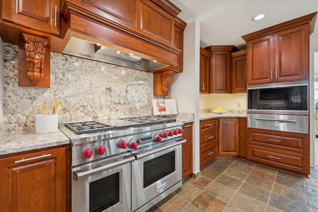 kitchen featuring custom exhaust hood, double oven range, light stone countertops, and black microwave