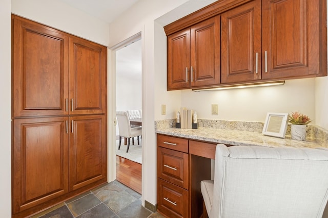 kitchen with built in desk and light stone counters