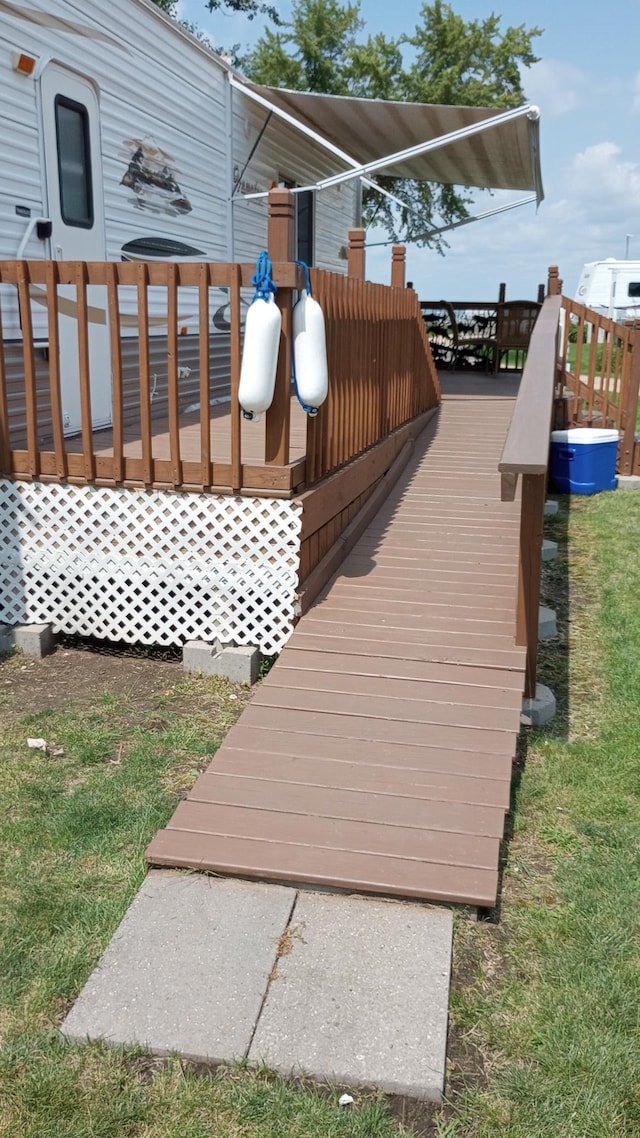 wooden terrace featuring a yard