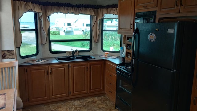 kitchen with light tile patterned floors, black appliances, and sink