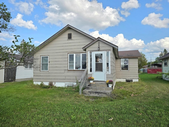 back of house featuring a lawn