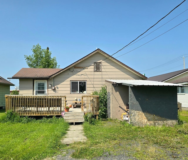 back of property featuring a yard and a wooden deck