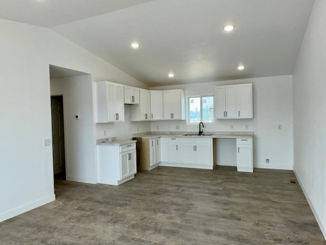 kitchen featuring white cabinetry, lofted ceiling, recessed lighting, and baseboards