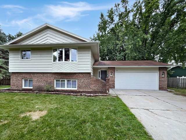 split level home with a garage and a front lawn