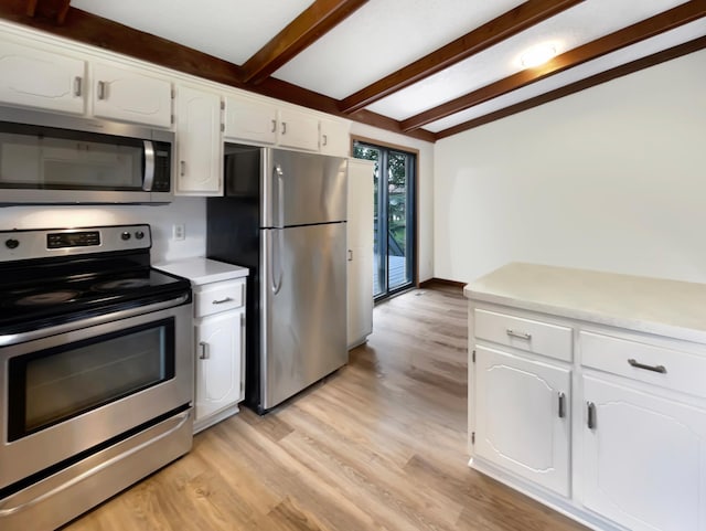 kitchen featuring appliances with stainless steel finishes, light hardwood / wood-style flooring, white cabinets, and beam ceiling