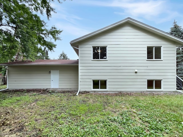 back of property featuring a lawn