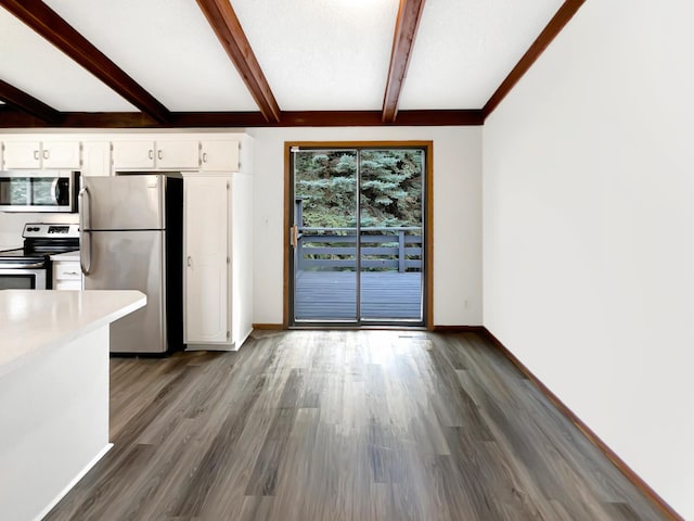 kitchen featuring white cabinets, stainless steel appliances, hardwood / wood-style floors, and beam ceiling