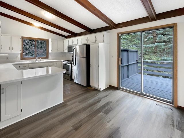 kitchen featuring vaulted ceiling with beams, white cabinets, dark hardwood / wood-style flooring, stainless steel appliances, and sink