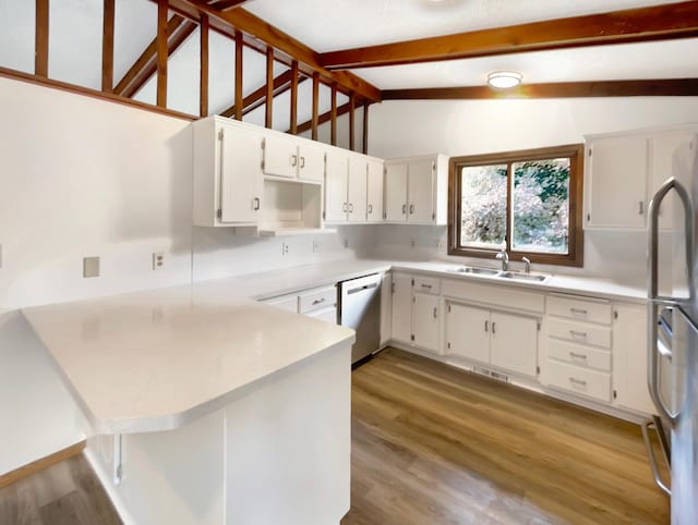 kitchen featuring vaulted ceiling with beams, stainless steel appliances, sink, light hardwood / wood-style flooring, and kitchen peninsula