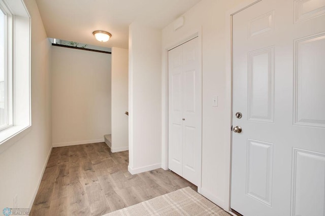 interior space featuring light wood finished floors and baseboards