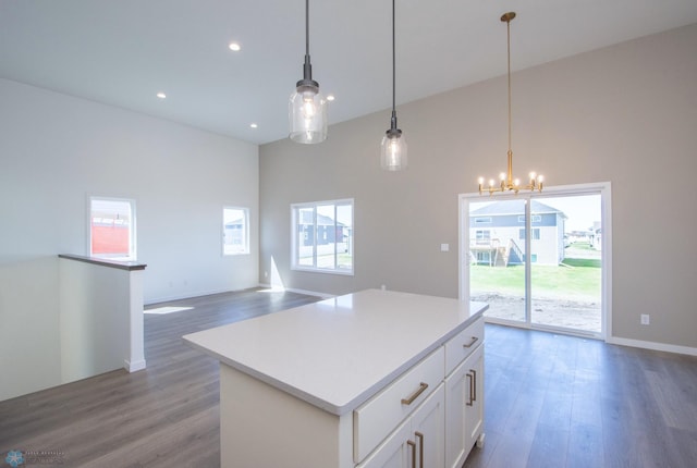 kitchen featuring plenty of natural light, wood finished floors, and a center island