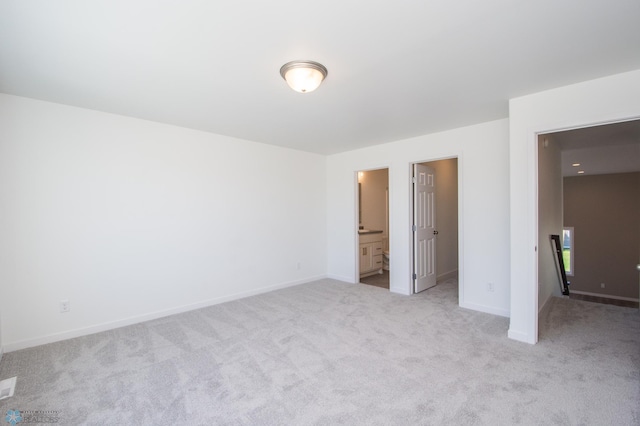 unfurnished bedroom with light colored carpet, baseboards, and visible vents