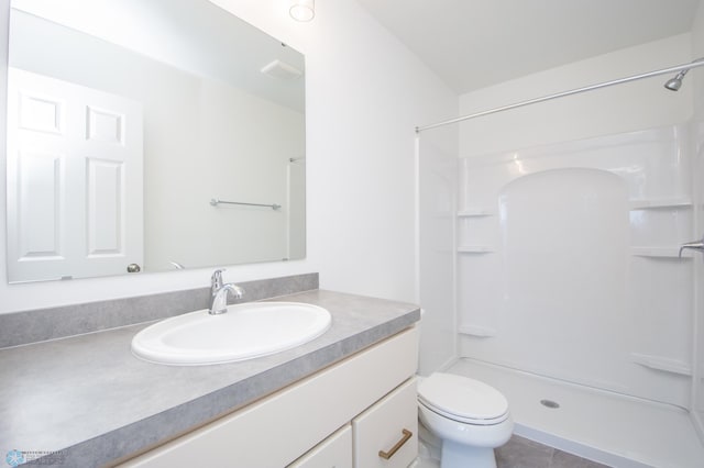 bathroom with toilet, a shower, and vanity