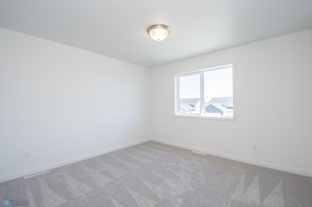 carpeted empty room with baseboards