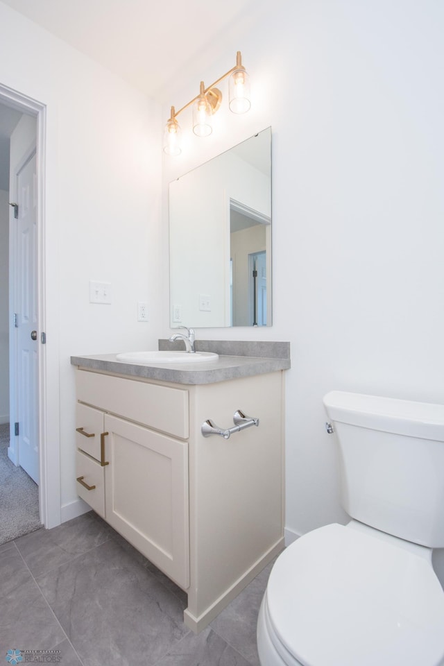 bathroom featuring toilet and vanity
