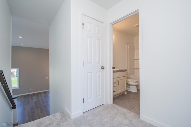 corridor featuring carpet flooring, recessed lighting, and baseboards