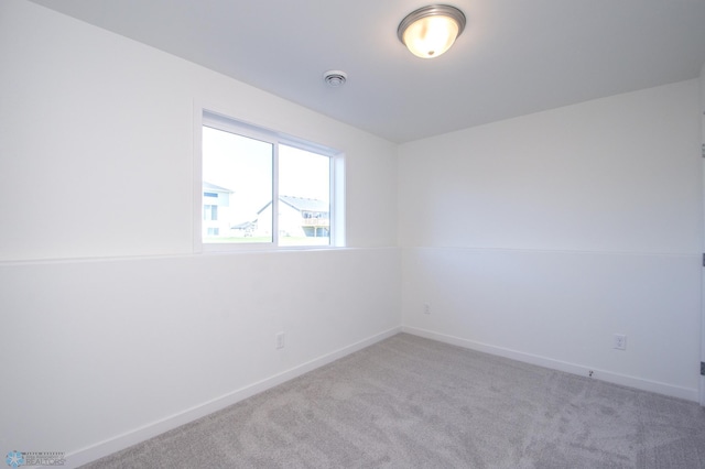 spare room with baseboards and carpet flooring