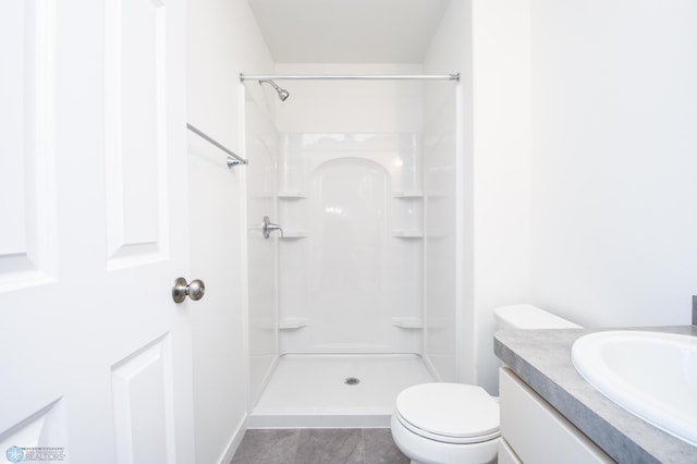 full bathroom with vanity, a shower, and toilet