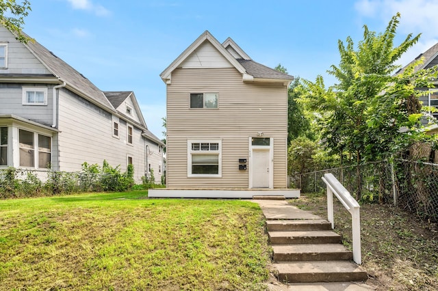 rear view of house with a yard