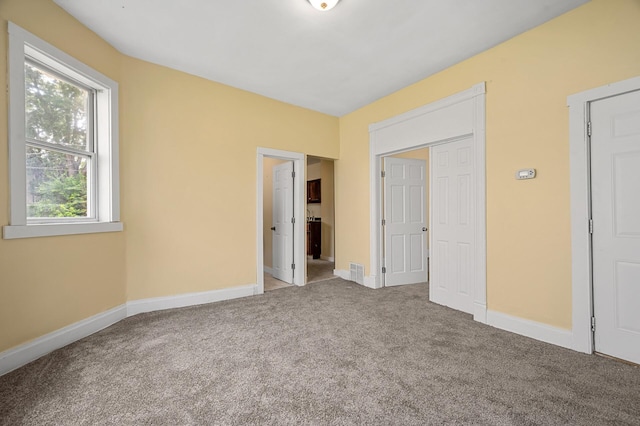 unfurnished bedroom featuring light colored carpet