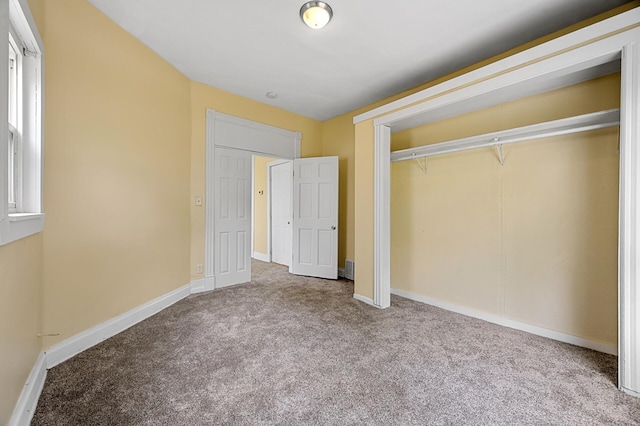 unfurnished bedroom with a closet and carpet