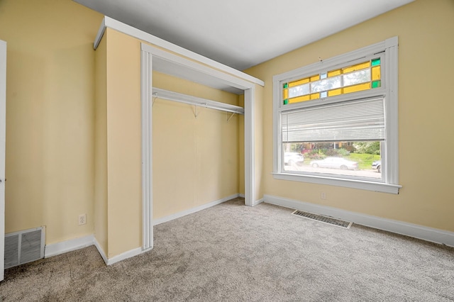 unfurnished bedroom featuring carpet and a closet