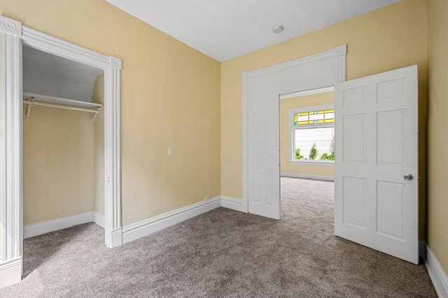 unfurnished bedroom with a closet and carpet flooring