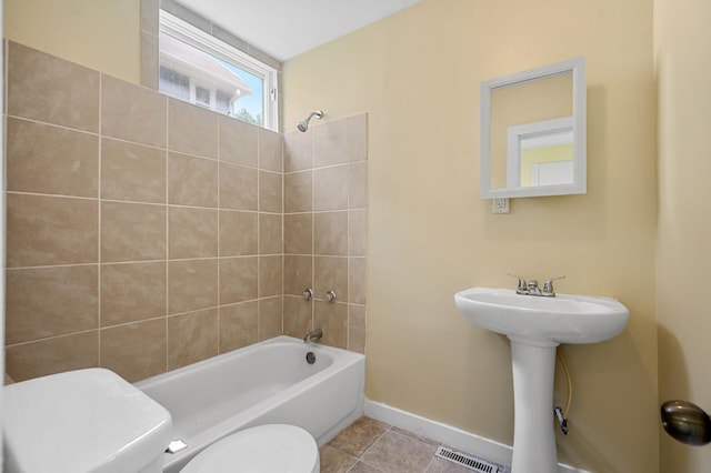 full bathroom with sink, tile patterned flooring, toilet, and tiled shower / bath