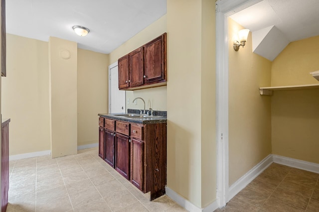 bar featuring sink and light tile patterned flooring