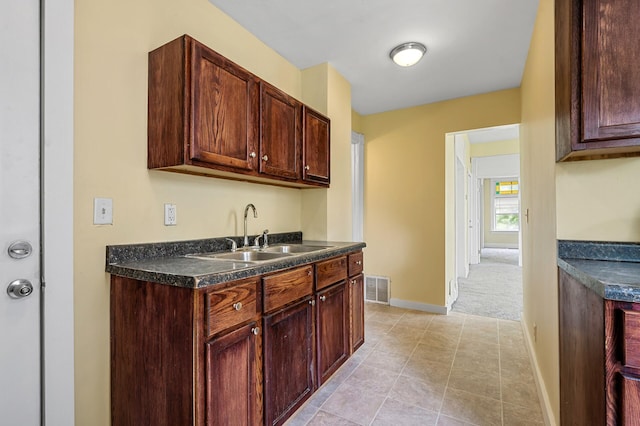 kitchen with sink and light tile patterned flooring