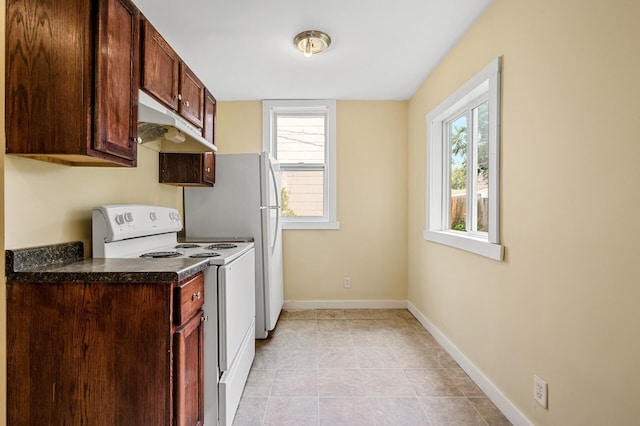 kitchen featuring white electric stove, a wealth of natural light, and light tile patterned floors