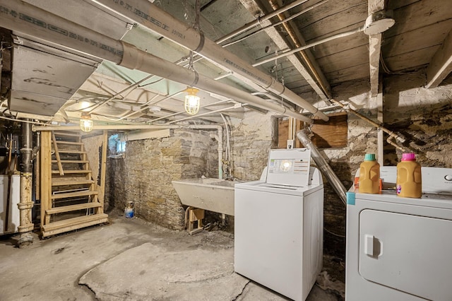 basement featuring sink and washer and dryer