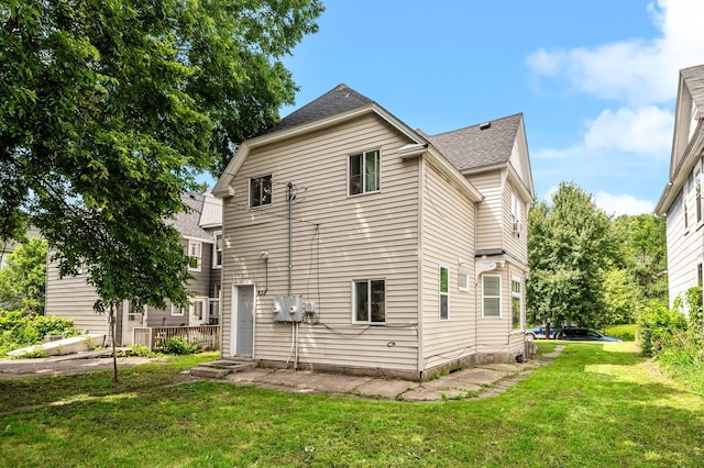 rear view of house with a yard