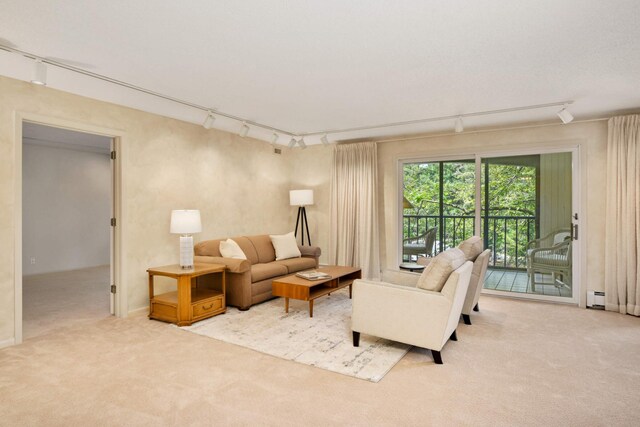 living room with light carpet, baseboard heating, and rail lighting