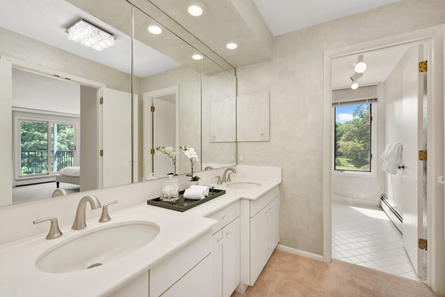 bathroom with baseboard heating, vanity, and tile patterned floors