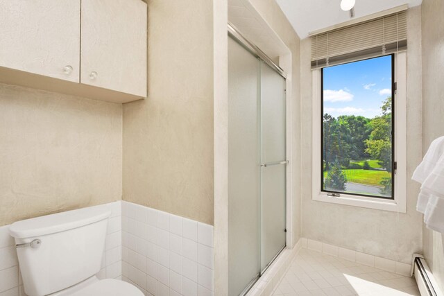 bathroom featuring a shower with door, a baseboard radiator, toilet, and tile patterned floors