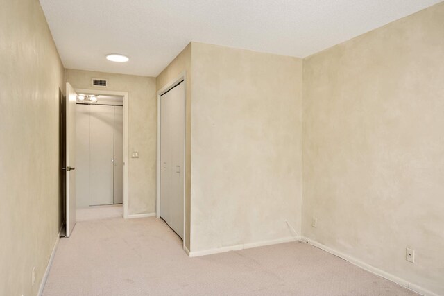 corridor with light colored carpet