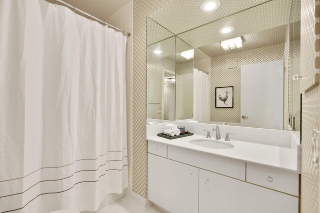 bathroom featuring vanity, a shower with curtain, and tile patterned floors