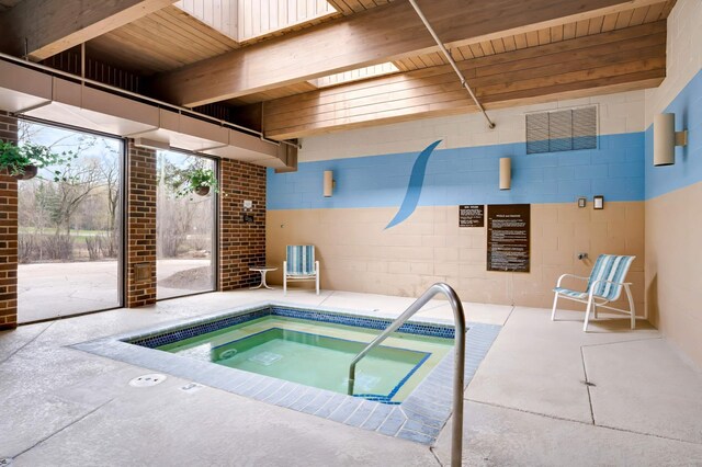 view of swimming pool with an indoor hot tub and a patio