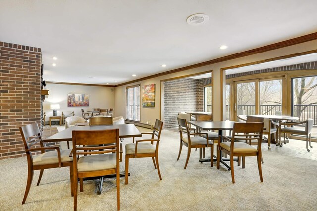 carpeted dining area featuring ornamental molding