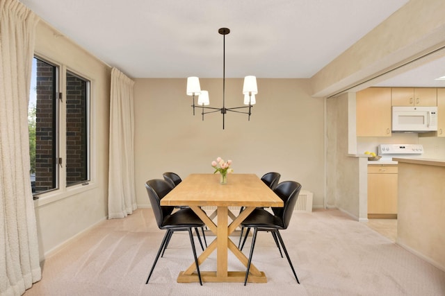 dining space featuring a notable chandelier and light carpet